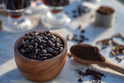 Coffee beans, wooden spoon, items for making coffee at home