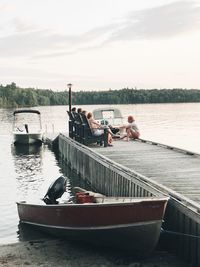Boats moored on river against sky