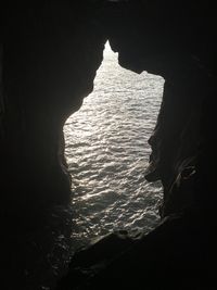 Scenic view of sea seen through cave