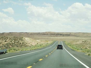 Country road leading towards mountains