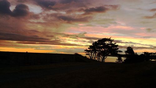 Silhouette of landscape against cloudy sky