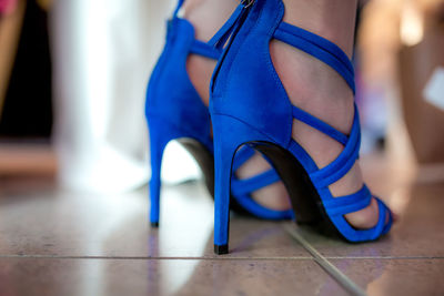 Low section of woman standing on tiled floor