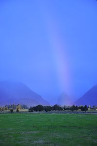 Scenic view of grassy field against cloudy sky