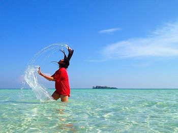 Woman jumping in sea