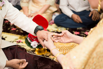 Midsection of couple holding hands