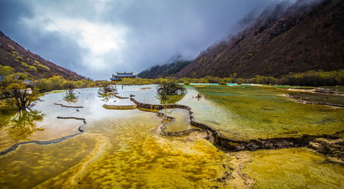 Scenic view of lake and mountains against sky