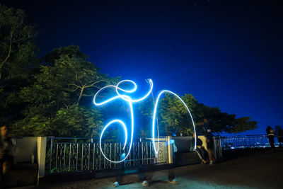 Light painting against blue sky at night