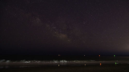 Scenic view of sea against sky at night