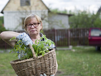 Portrait of young man wearing basket outdoors