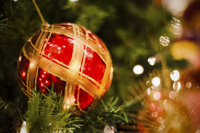 Close-up of decoration on illuminated christmas tree at night