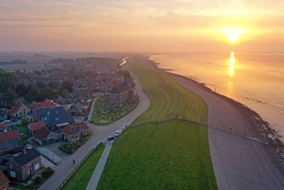 Aerial from the village wierum at the wadden sea in the netherlands at sunset