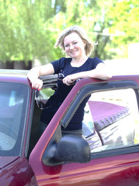 Portrait of smiling woman in car