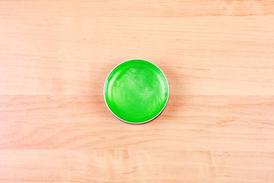 High angle view of green hair gel on table