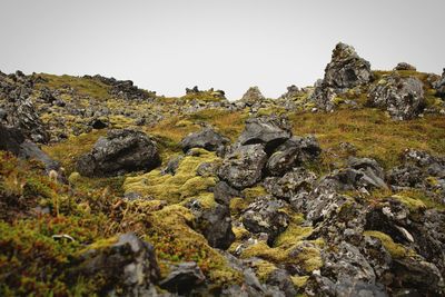 Rock formations on landscape against clear sky