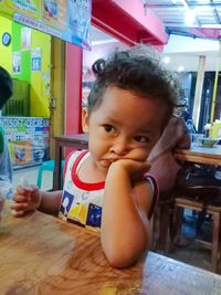 Portrait of cute boy looking at table