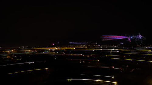 Illuminated city against sky at night