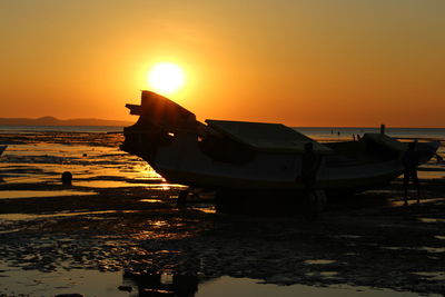 Scenic view of sea against orange sky