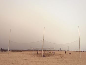 Men playing beach soccer