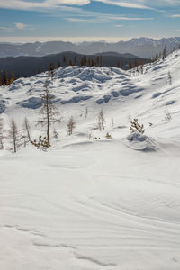 Scenic view of snow covered mountains against sky