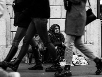 Low section of people standing on street