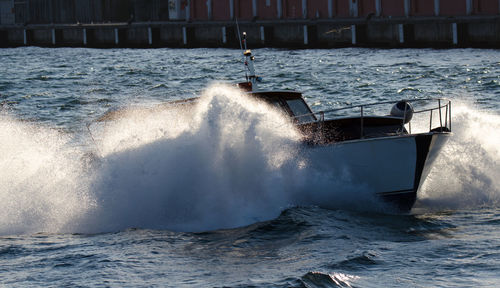 Scenic view of sea waves splashing on boat