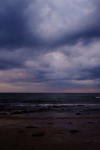 Scenic view of beach against sky during sunset