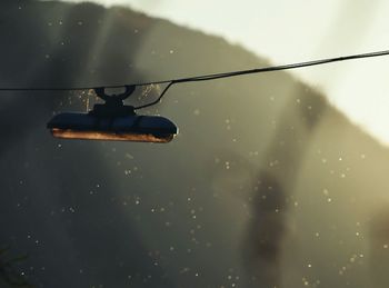 Close-up of wet windshield against sky