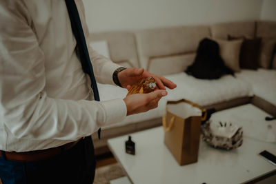 Midsection of man getting ready at home