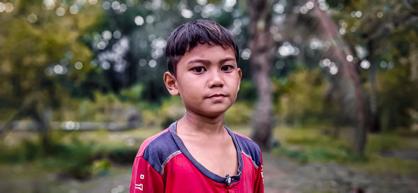 Portrait of boy standing on land