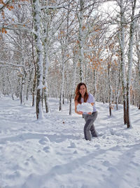 Full length of woman on snow covered field