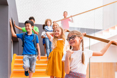 Low angle view of kids standing on staircase