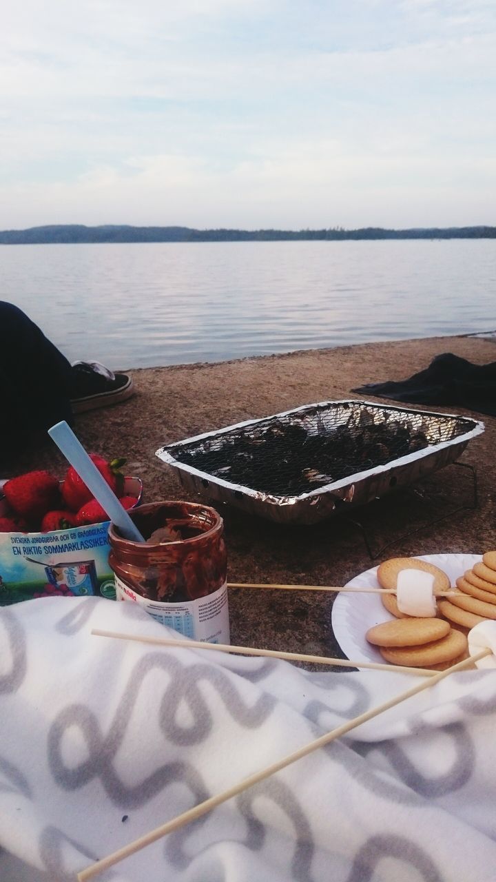 sea, food and drink, table, water, sky, beach, drink, sweet food, horizon over water, refreshment, tranquil scene, still life, shore, freshness, tranquility, day, coffee cup, no people, dessert, indoors