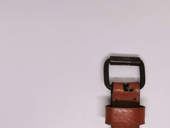 Close-up of telephone booth against white wall