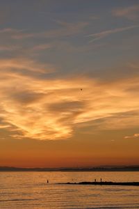 Scenic view of sea against orange sky