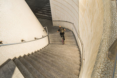 High angle view of man riding bicycle on staircase