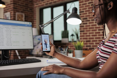 Midsection of woman using digital tablet