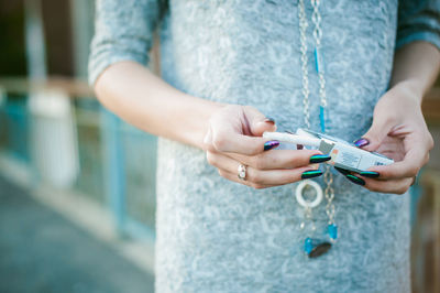 Midsection of woman using mobile phone