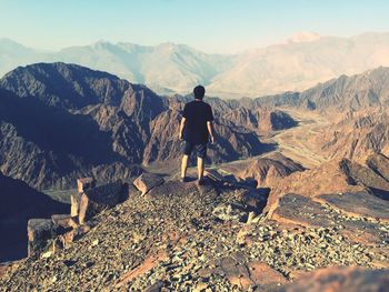 Rear view of man walking on mountain
