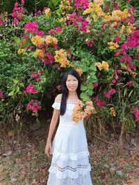 Woman in white dress wirh colourful yellow and pink flowers