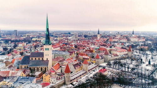 High angle view of buildings against cloudy sky in town