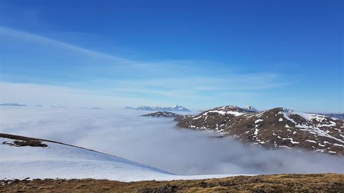 Scenic view of snowcapped mountain against blue sky