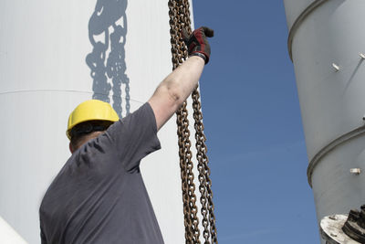 Low angle view of man working at construction site