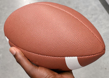 Close-up of hand holding football