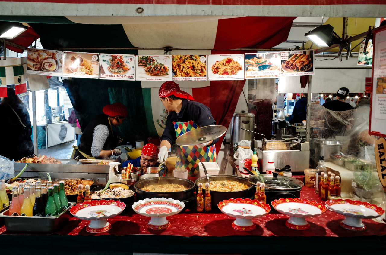 PEOPLE WORKING AT MARKET STALL FOR SALE AT STREET