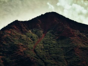 Scenic view of mountains against cloudy sky