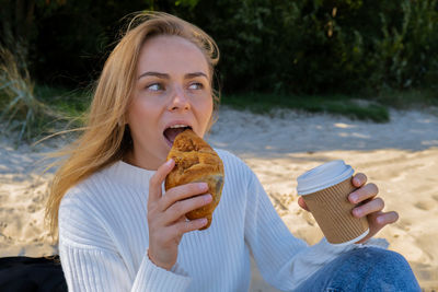 Portrait of woman holding food