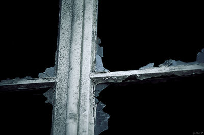 Low angle view of icicles against blurred background