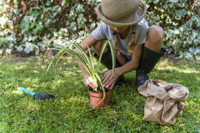 Midsection of woman holding grass