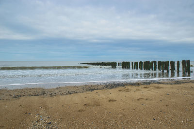 View of beach against cloudy sky