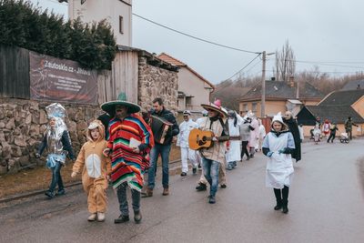 People walking on road against buildings